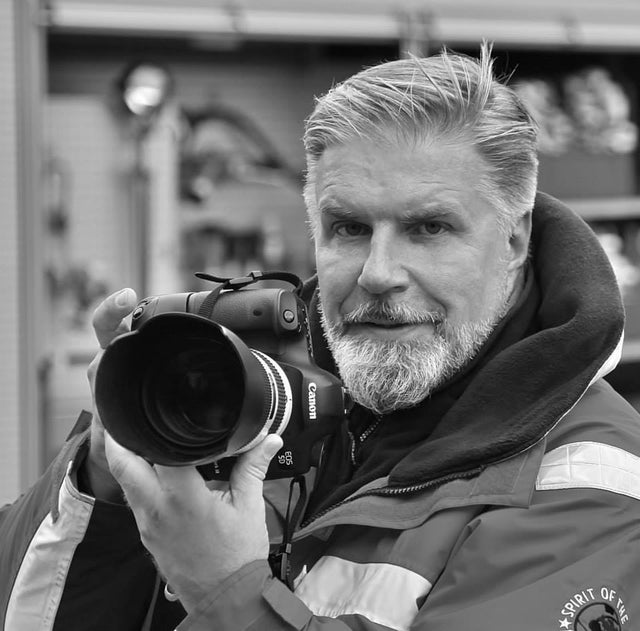 Ismo Jokinen with camera on black-and-white image